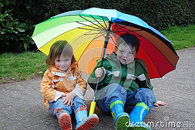 Siblings with umbrella Stock Photo