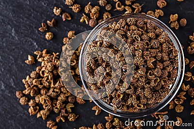 Sichuan pepper on a dark stone background Stock Photo
