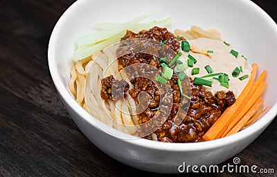 Sichuan Spicy Noodle with garlic chili oil and minced pork, serving on white bowl. Traditional food of Sichuan province. Chinese Stock Photo