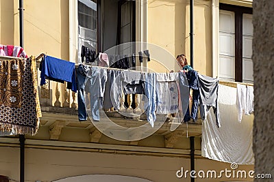 Old Woman Hanging Clothes Editorial Stock Photo