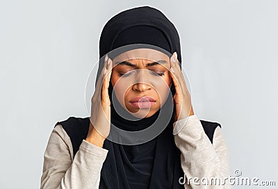 Sick Afro Muslim Girl In Hijab Touching Temples, Suffering From Headache Stock Photo
