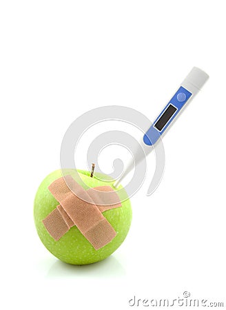 Sick apple with thermometer and patches Stock Photo