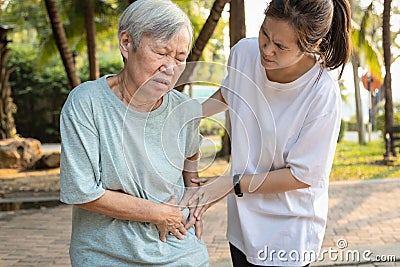 Sick asian senior woman with belly pain,elderly have severe stomach ache,left side,patient with acute pancreatitis hold hand left Stock Photo