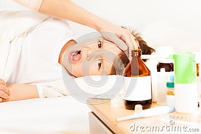 Sick boy crying while mother checking temperature Stock Photo