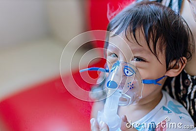 Sick boy inhalation therapy by the mask of inhaler. Baby has asthma and need nebulizations Stock Photo