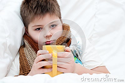 Sick boy lying in bed Stock Photo