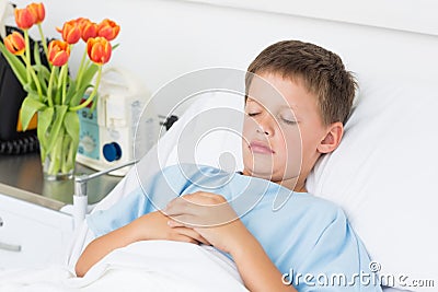 Sick boy sleeping in hospital bed Stock Photo