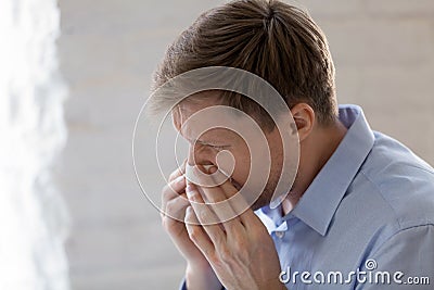 Sick businessman with runny nose holding handkerchief close up Stock Photo