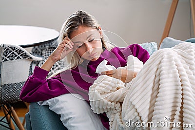 Sick desperate woman has flu. Rhinitis, cold, sickness, allergy concept. Pretty sick woman has runnning nose, rubs nose with Stock Photo