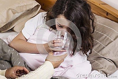 Sick Girl Drinking Water Stock Photo