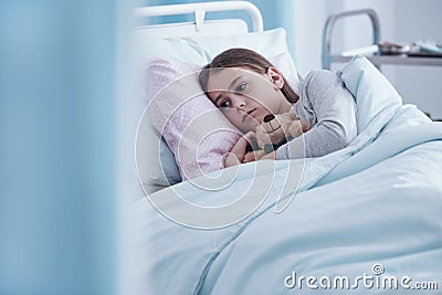 Sick girl in hospital bed Stock Photo