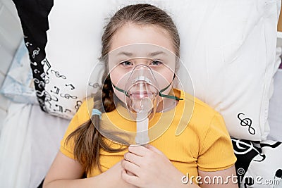 The sick girl inhales. Inhalation of the upper respiratory tract Stock Photo