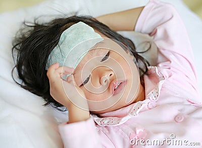 Sick girl lying on the bed with a cool jell in the face Stock Photo