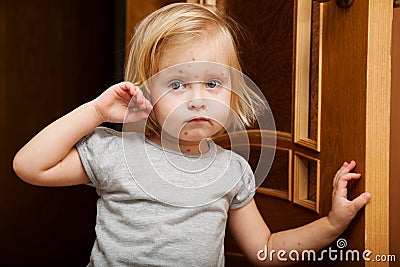 A sick girl is near the door Stock Photo