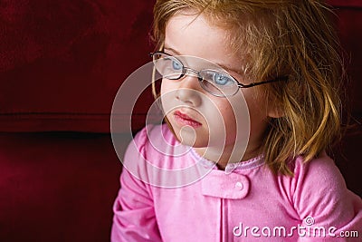 Sick Girl With Very Thick Glasses and Magnified Blue Eyes Stock Photo