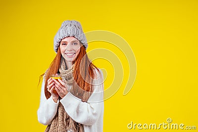 Sick illness redhaired ginger woman good looking wearing knitted sweater and hat with scarf drinking hot tea cup with Stock Photo