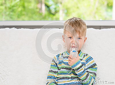 Sick little boy makes inhalation home Stock Photo