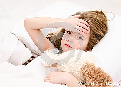 Sick little girl lying in the bed Stock Photo