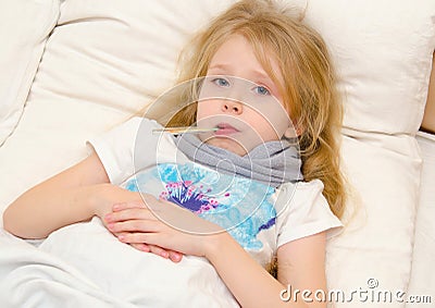 Sick little girl lying in the bed with temperature Stock Photo