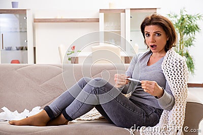 Sick middle-aged woman suffering at home Stock Photo