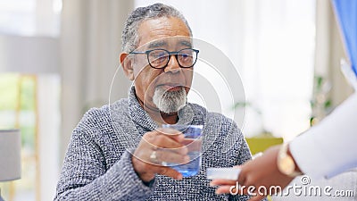 Sick, nurse or senior man in home to take pills or supplements for healthcare vitamins or wellness. Drinking water Stock Photo