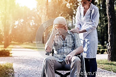 Sick old man and the doctor on green park Stock Photo