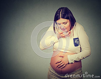 Sick pregnant woman with nausea morning sickness about to throw up Stock Photo