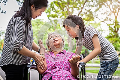 Sick senior grandmother in wheelchair with epileptic seizures in outdoor,elderly patient convulsions suffering from illness with Stock Photo