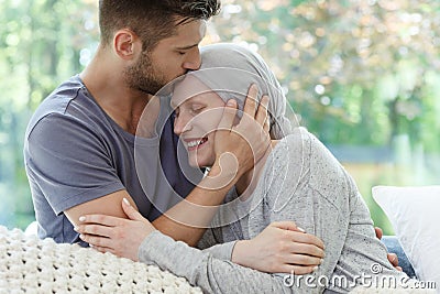 Sick woman being kissed Stock Photo