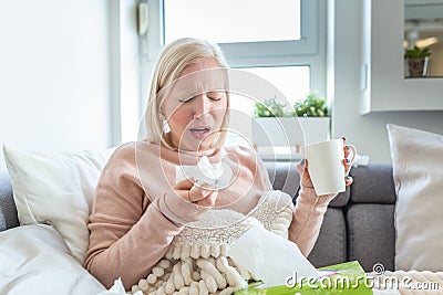 Sick Woman.Flu.Woman Caught Cold. Sneezing into Tissue. Headache. Virus .Medicines. Young Woman Infected With Cold Blowing Her Stock Photo