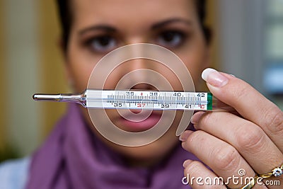 The sick woman with flu and fever thermometers Stock Photo