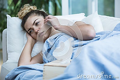 Sick woman with phone Stock Photo