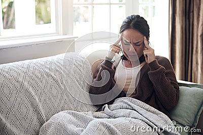 Sick woman, tissue and headache with sinus, flu or pain from illness on living room sofa at home. Tired female person Stock Photo