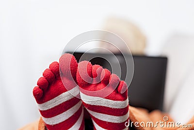 Sick women in funny toesocks on couch Stock Photo