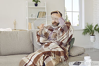 Unhealthy man suffer from flu measure temperature Stock Photo