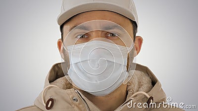 Sick young man handsome wearing medical mask on gradient background. Stock Photo