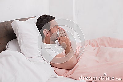 Sick young man sneeze concept Stock Photo
