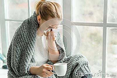 Sick young woman with cold and flu at home Stock Photo