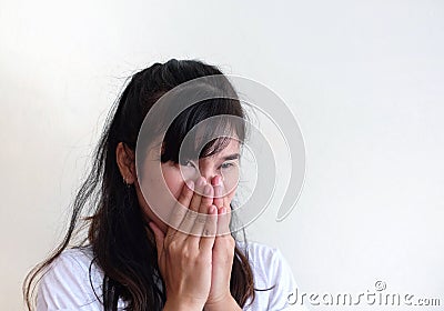 Sick young woman having runny nose, holding hand on nose Stock Photo