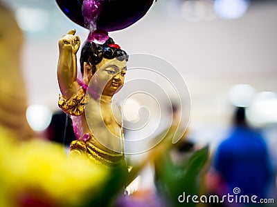 Siddhartha Gautama Buddha Sculpture Flushed by Water and Flower Stock Photo