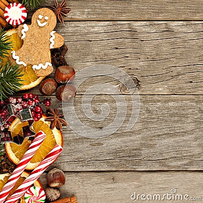 Side border of Christmas decor and treats over rustic wood Stock Photo