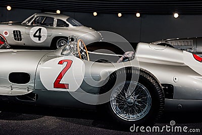 Side, close up view of grey retro sport coupe cabriolet, red number 2 painted on left door, with wooden steering wheel Editorial Stock Photo