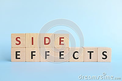 Side effects word on wooden blocks in blue background typography. Stock Photo