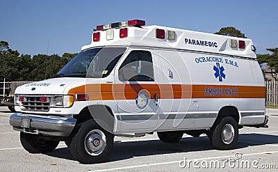 Side and front view of parked orange and white ambulance Editorial Stock Photo