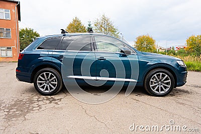 Side full length view of car wagon model in firmament blue metallic color in countryside. Luxury automobile loaded with Editorial Stock Photo