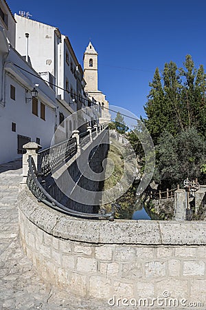 Side outlet of the roman bridge toward church of San Andres, take in Alcala of the Jucar, Albacete province, Spain Editorial Stock Photo