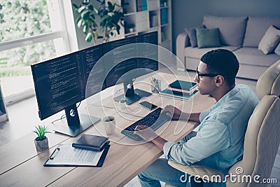 Side photo of young guy profession it specialist student studying exploring new app for coding modern technology indoors Stock Photo
