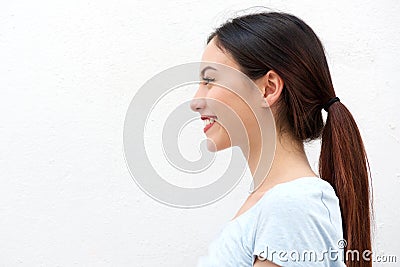 Side portrait of healthy young woman with long hair smiling Stock Photo
