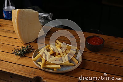 A side of potato fries with tomato sauce and cheese. Stock Photo