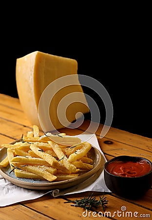 A side of potato fries with tomato sauce and cheese. Stock Photo